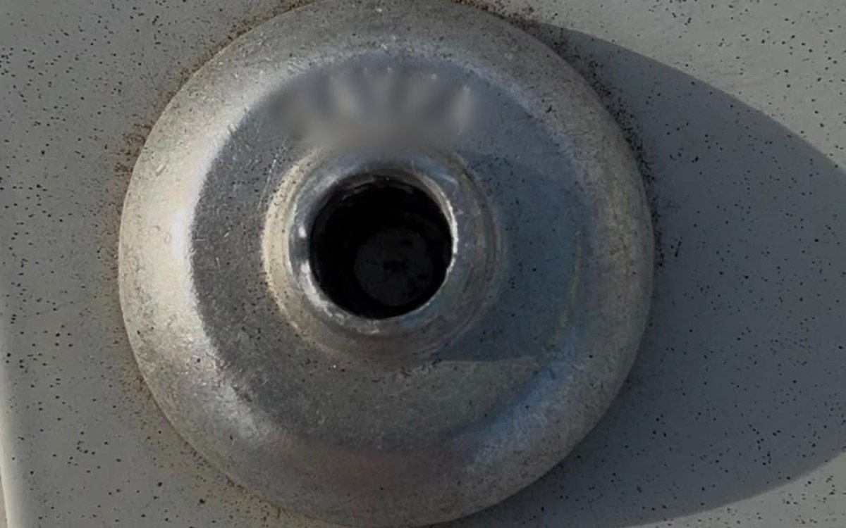Close-up of a failed rivet on a roof anchor base plate in Melbourne