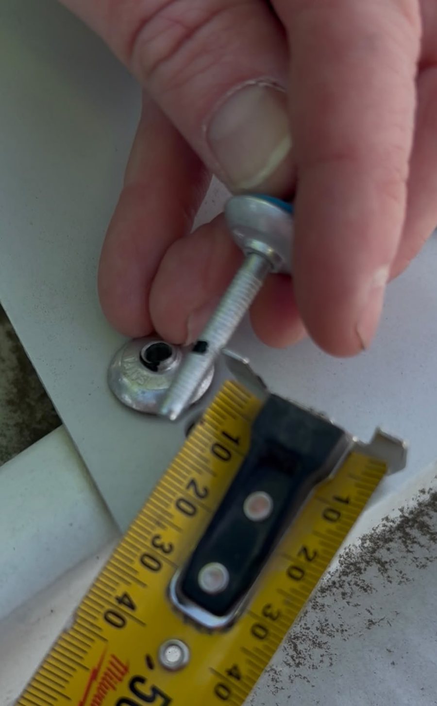 Measuring the marked depth probe against a tape measure