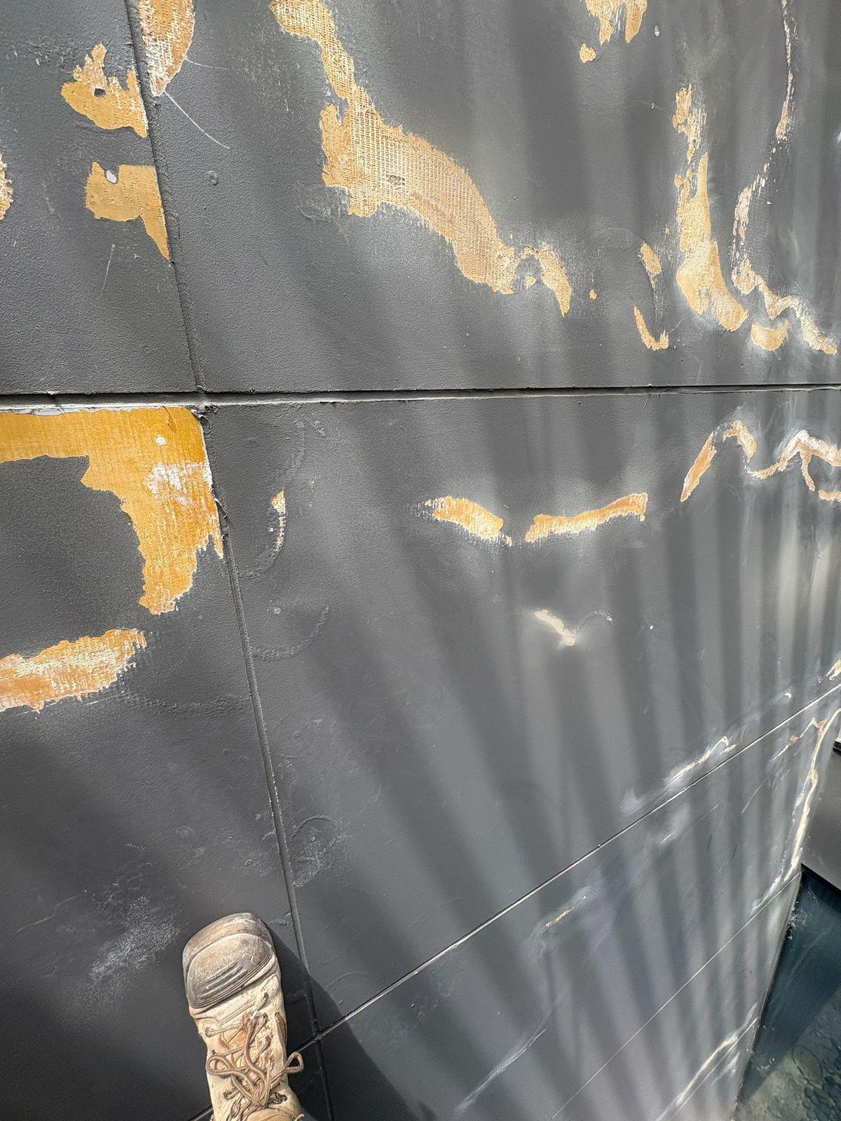 Peeling paint and failed filler patches on facade cladding Melbourne