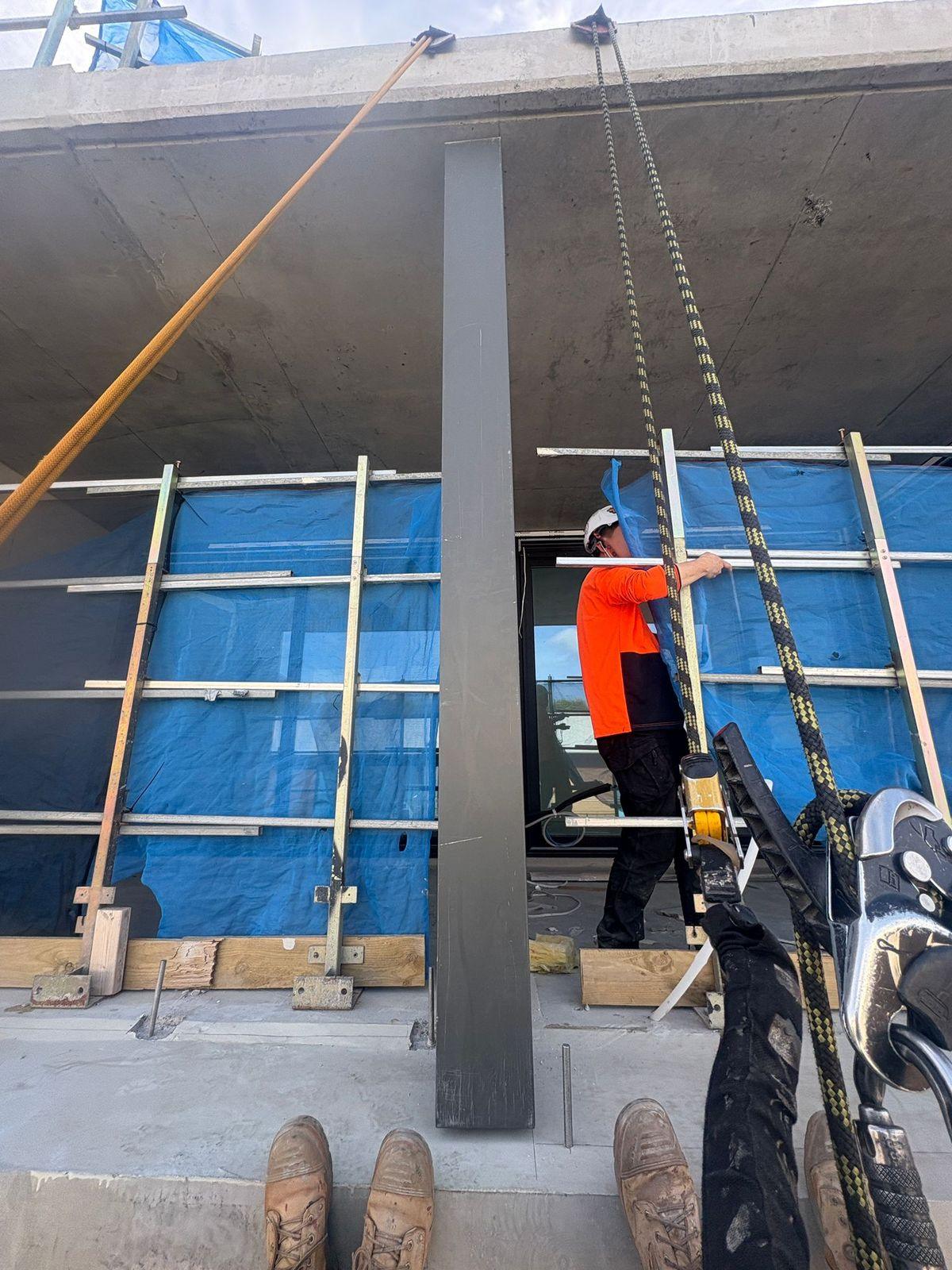 Facade fin installation at height on new residential building, Melbourne