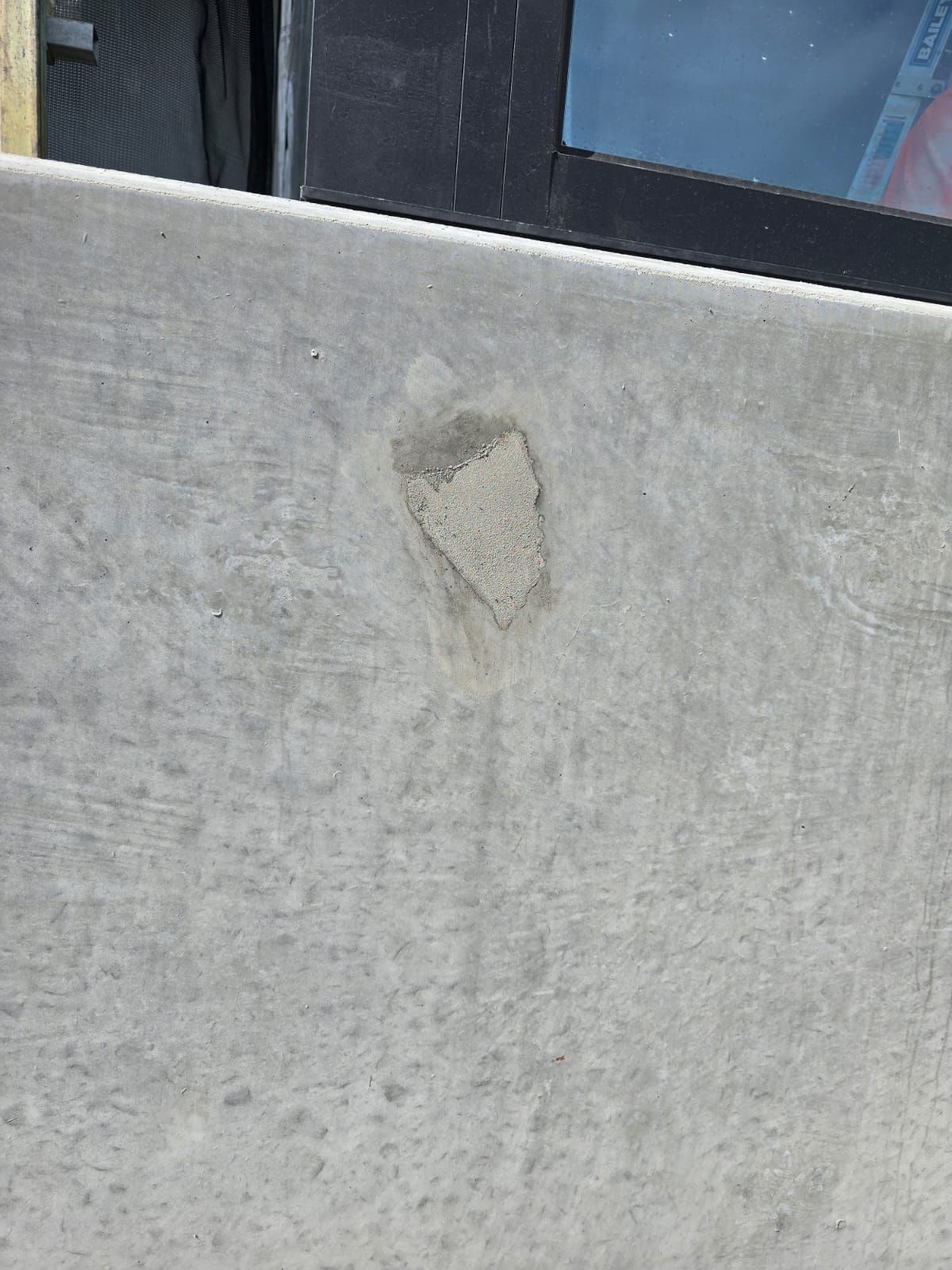 Concrete spall repaired and finished flush on facade, Carnegie Melbourne