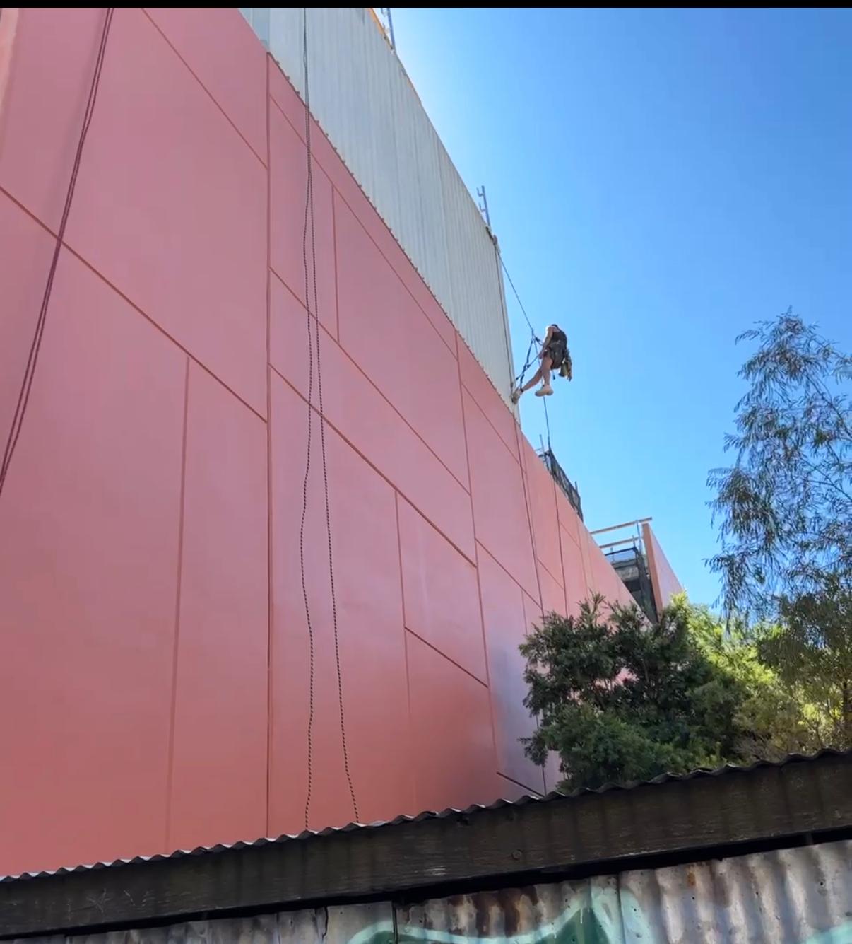 Hayes Height Services rope access technician painting large commercial facade Melbourne