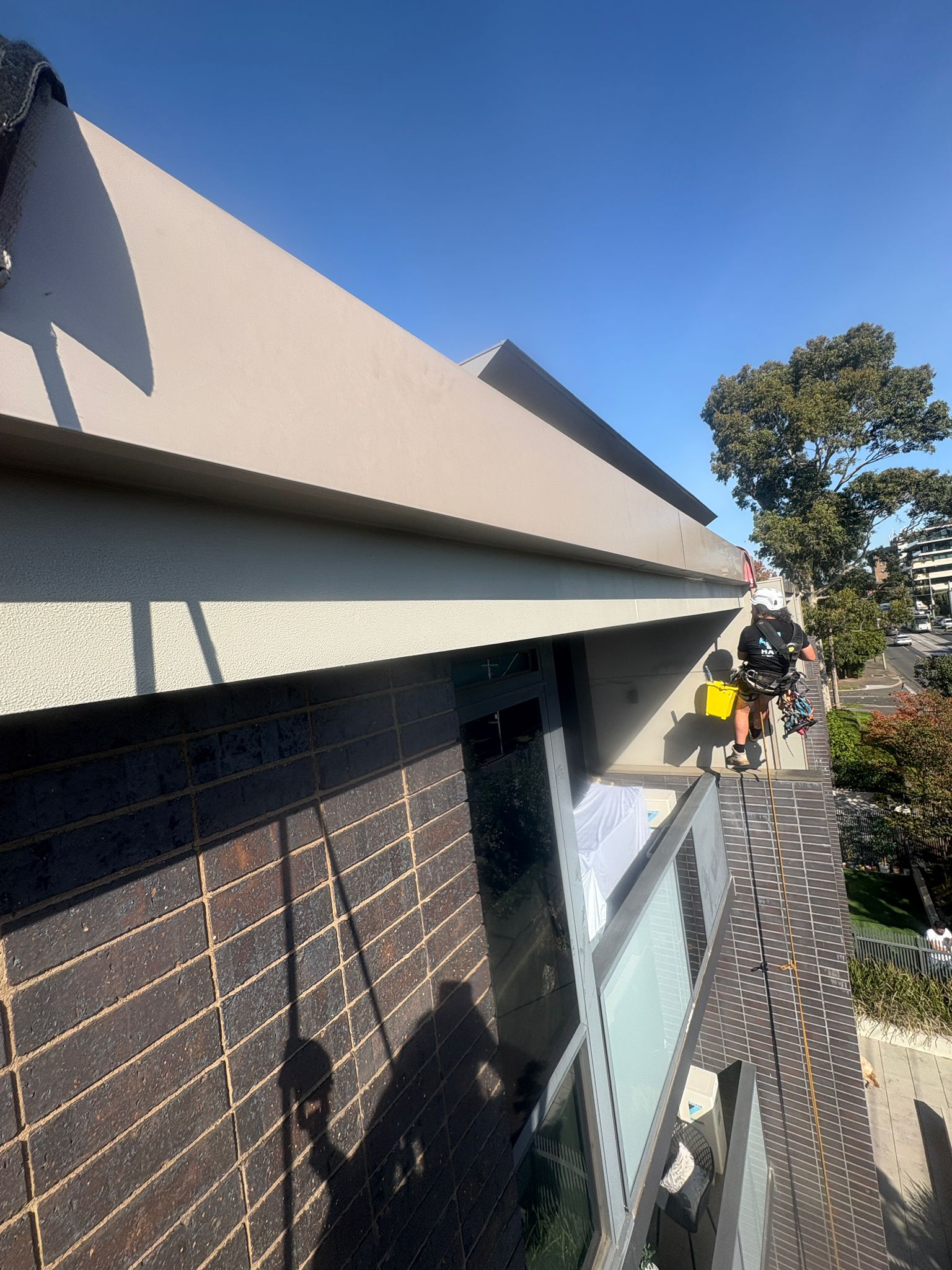 Hayes Height Services rope access painter working on Melbourne building facade
