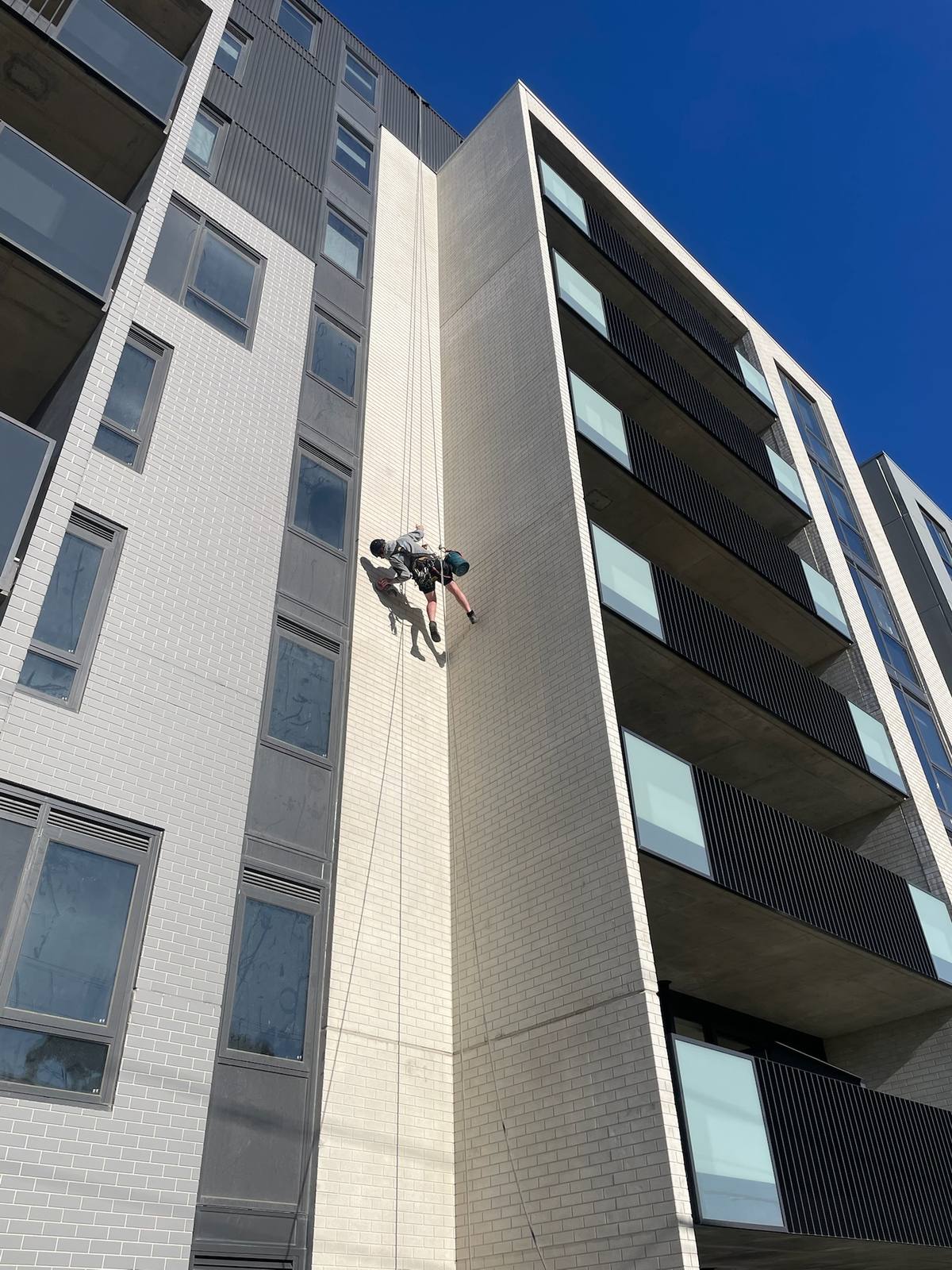 Rope access caulking work on commercial building Melbourne
